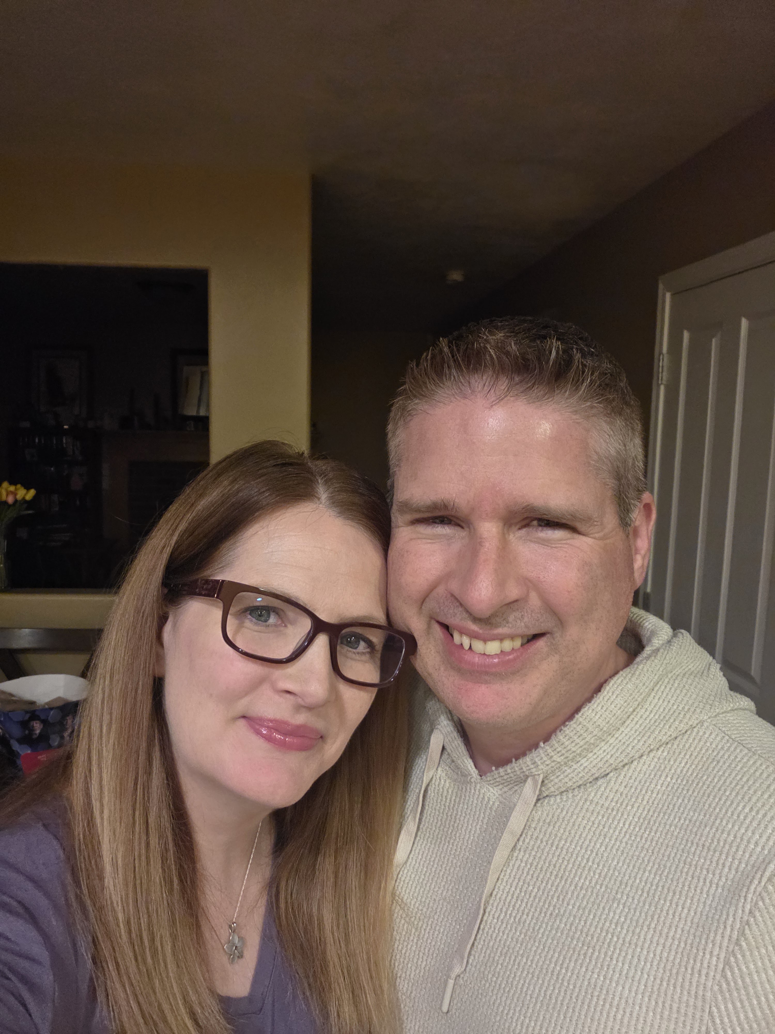 Kyle Erb and Mandy smiling together in a warm indoor selfie