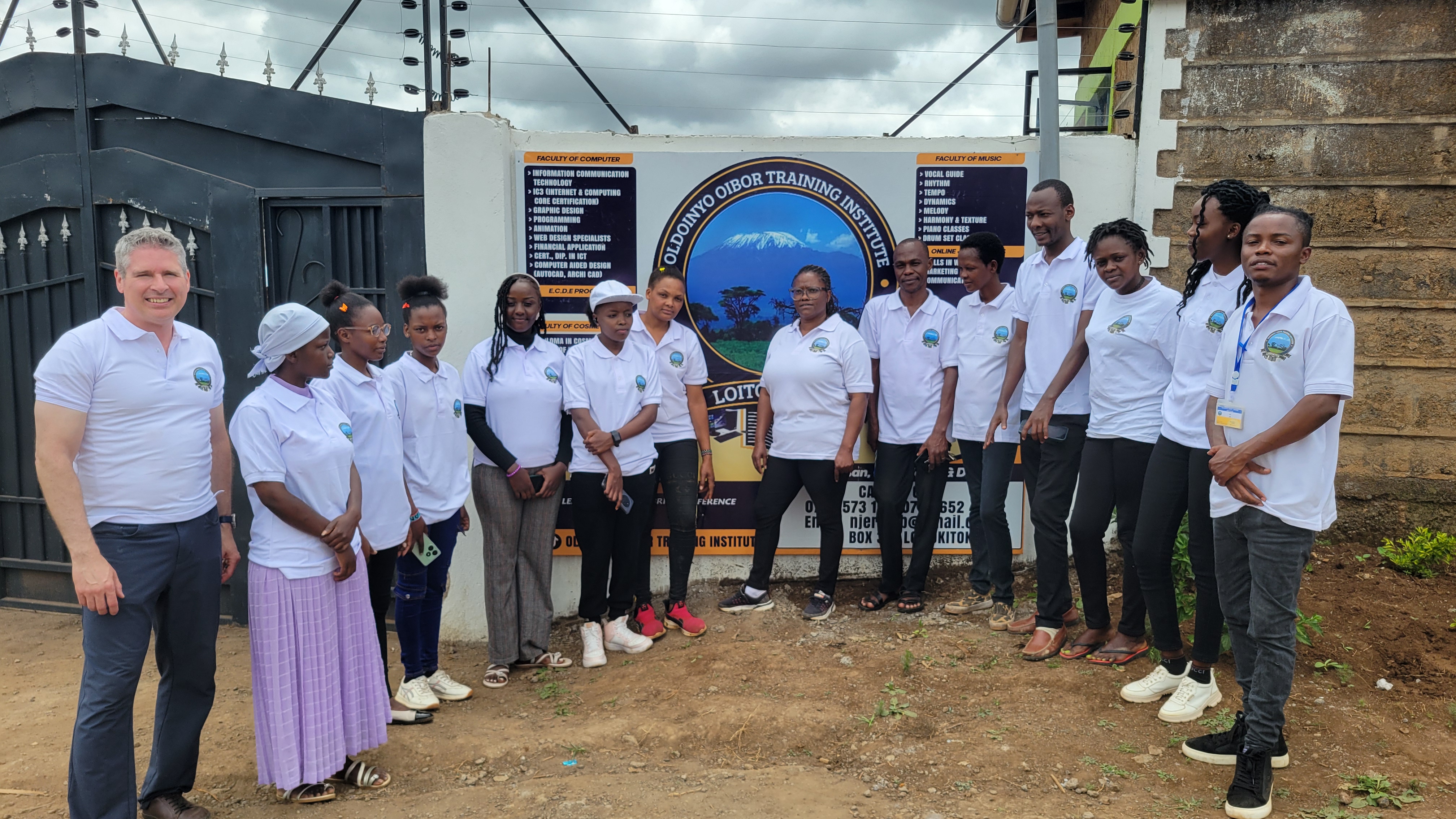 Kyle with students and staff outside Oldoinyo Oibor Training Institute in Oloitoktok, Kenya, in the foothills of Mt Kilimanjaro